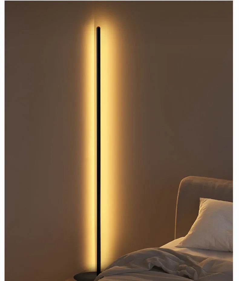 Simple modern vertical aluminium alloy floor lamp with LED light in a living room corner.