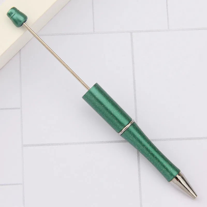 Colourful spinning ballpoint pen with plastic beads on a white background.