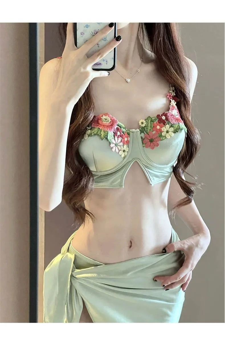 Green women's triangle bikini three-piece set with skirt on Asian size mannequin