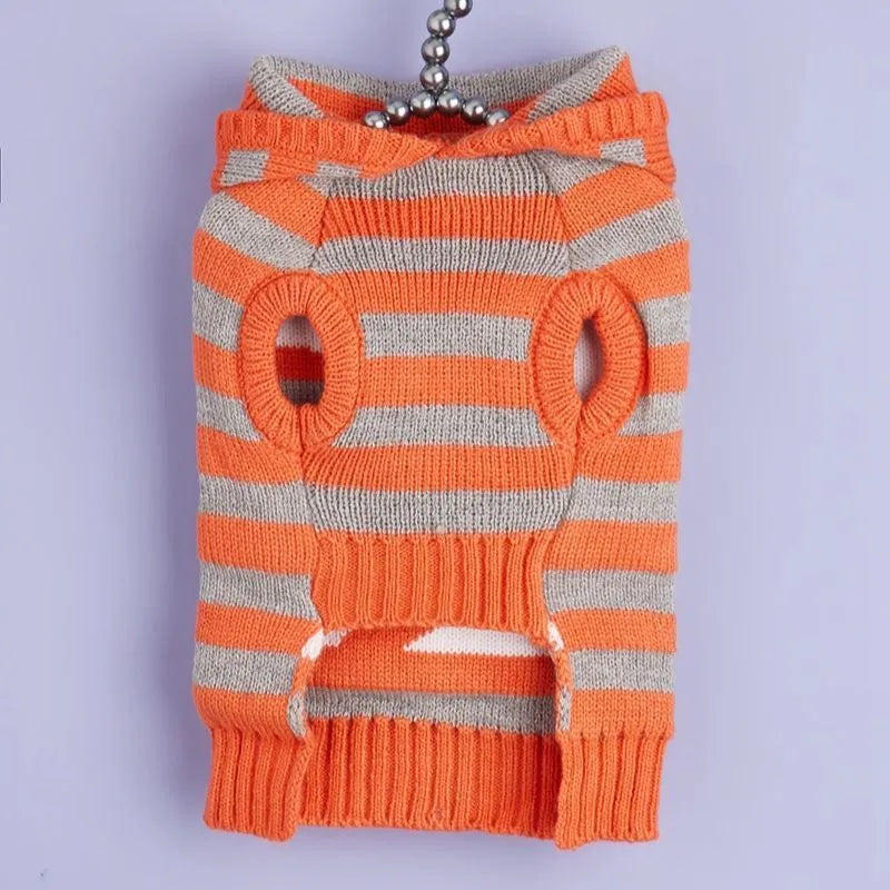 Orange Halloween knitted pet sweater with striped pattern and hooded design featuring fur ball decoration