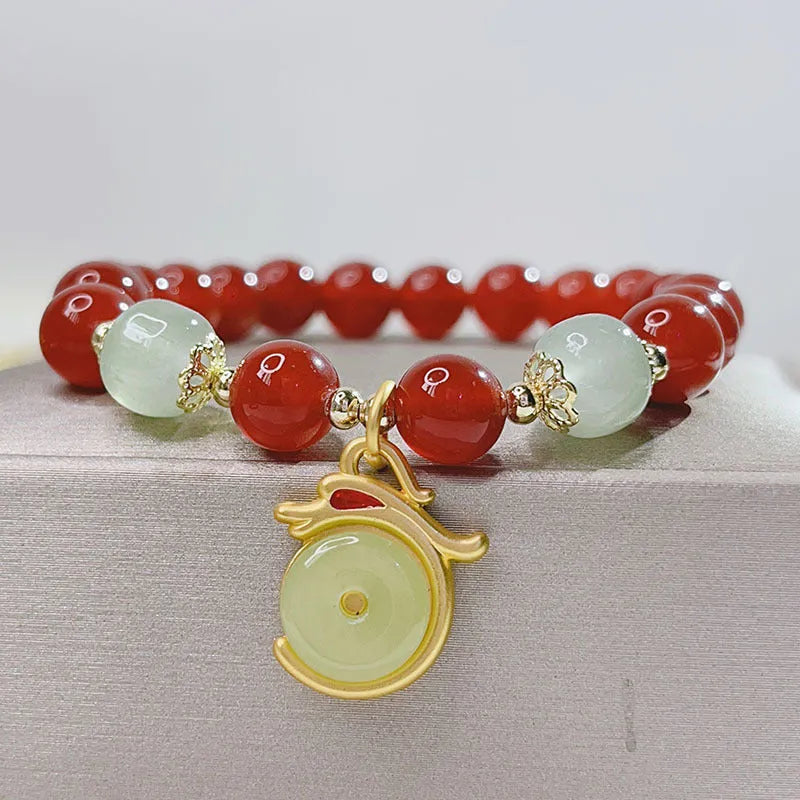 Handcrafted red agate bracelet for women with Chinese dragon design and lucky charm variations