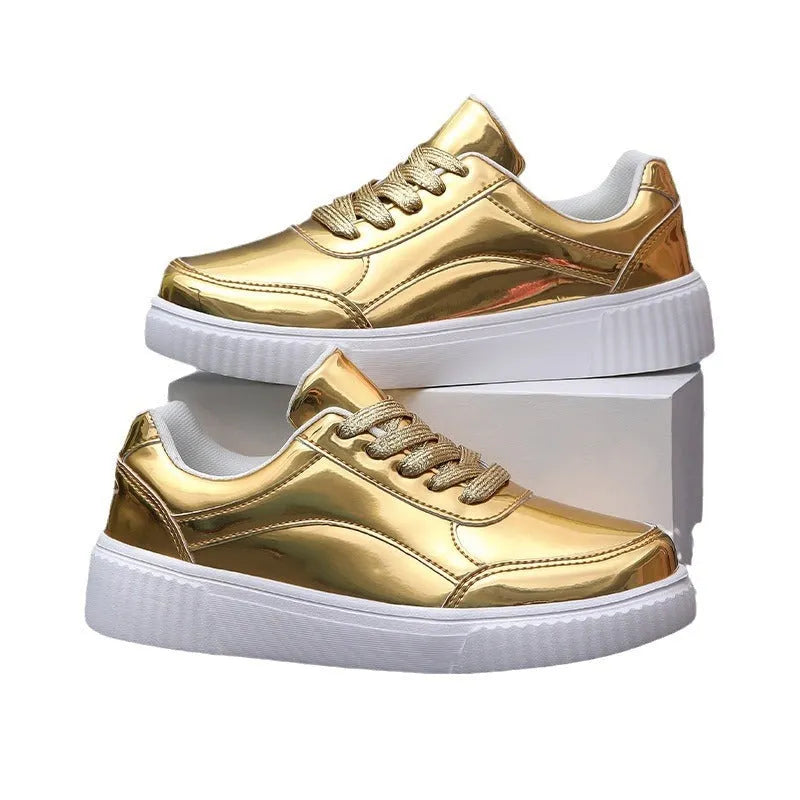 Gold sequinned platform sneakers with thick sole and round toe on a white background.