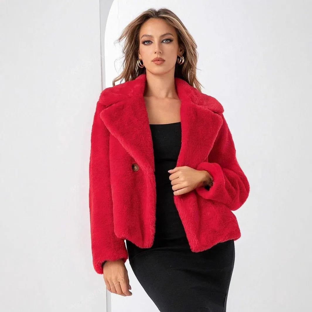 A women's rose red loose-fit short faux fur coat with regular sleeves on a hanger.